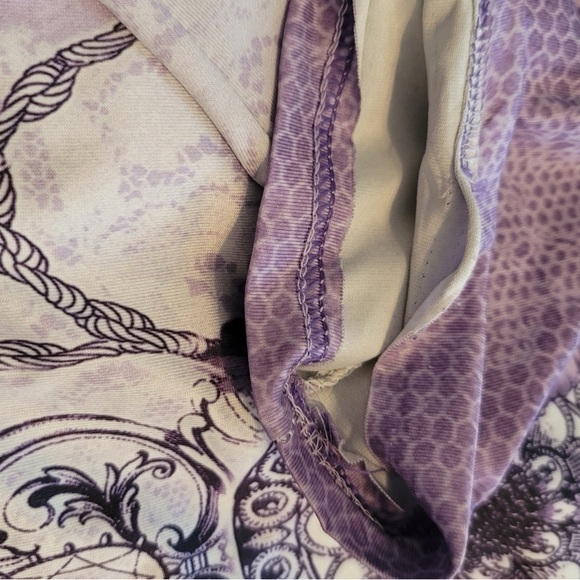 Short sleeve purple top with design. Material is loose fitting. - Picture 3 of 3